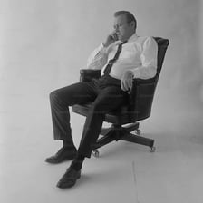 A person settling into a chair