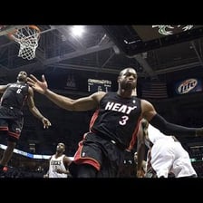Basketball player catching a pass near the rim for an alley-oop dunk