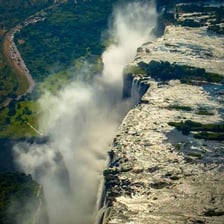 Fine water mist rising around a waterfall