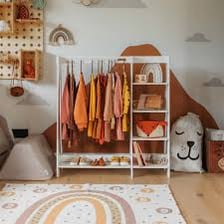 A wardrobe and clothing rack filled with assorted clothes