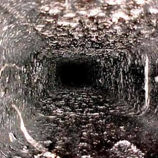 Black soot coating the inside of a wood-burning stove.