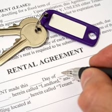 Apartment keys and a lease document representing rent
