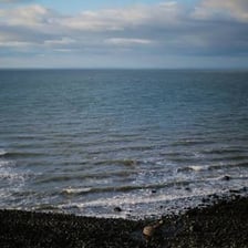 Seawater receding from a shoreline during an ebb tide