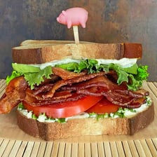 A sandwich filled with bacon, lettuce, and tomato