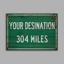 A highway sign displaying distances in miles