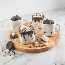 A ceramic mug containing hot chocolate.