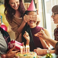 A person reacting with surprise to an unexpected celebration.