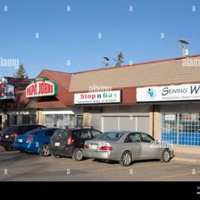 A row of retail storefronts in a strip mall.