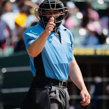 Baseball umpires wearing blue uniforms during a game