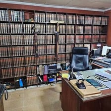 An attorney working beside legal books in an office