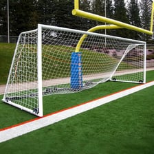 A net attached to a soccer goalpost on a field.