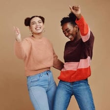 Two people standing together as a pair.