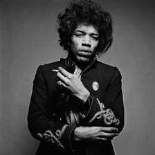 A portrait of Jimi Hendrix wearing his distinctive afro hairstyle