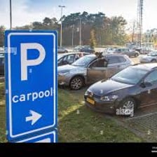 Cars sharing a ride and vehicles parked in a parking lot.