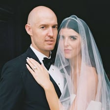 A woman wearing an engagement ring in a wedding-related portrait.