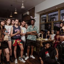 A group of regular patrons spending time inside a neighborhood cafe.