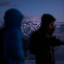 A photographer examining a photograph with an out-of-focus image