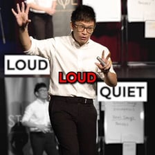 A presenter emphasizing an important point to an audience.