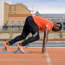 A track athlete sprinting from the starting blocks