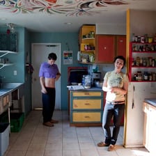 Two people sharing a home and spending time together in a kitchen.