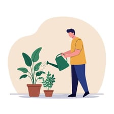 A person watering green houseplants with a watering can