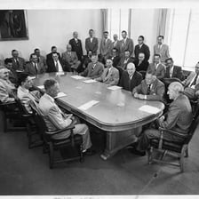 A group of trustees meeting around a conference table.