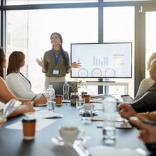A person confidently delivering a successful presentation