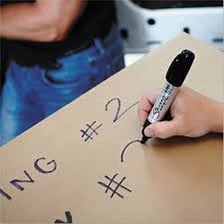 Dark permanent-marker writing on a sheet of white paper