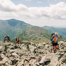 A hiker traveling across a mountain ridge