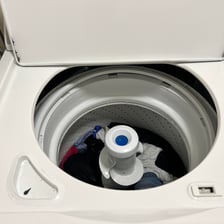 Clothes visible inside the drum of a washing machine.