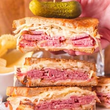 A Reuben sandwich with corned beef, sauerkraut, Swiss cheese, and rye bread