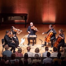 Five classical musicians performing together as a quintet