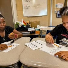 Students working on written exercises in a classroom