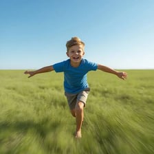 A young boy behaving in a playful and energetic way outdoors.