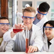 Students conducting a chemistry experiment in a classroom laboratory.