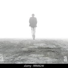 A person fading from view in a misty scene