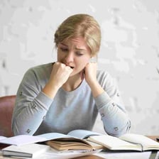 A visibly nervous person fidgeting before an exam.