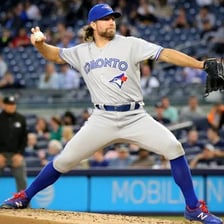 A baseball pitcher demonstrating a knuckleball grip and delivery.