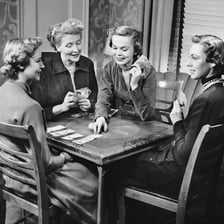 Players seated around a table playing the card game bridge.