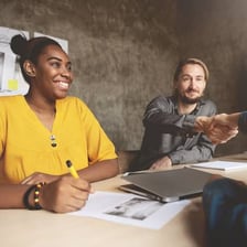 Job applicants speaking with a hiring manager in an office.