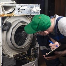 A machine that has stopped working while a technician examines it.