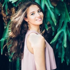 A portrait of a person smiling warmly.