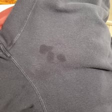 Piece of fabric visibly marked with dark stains