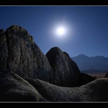 A landscape illuminated by bright moonlight in the evening