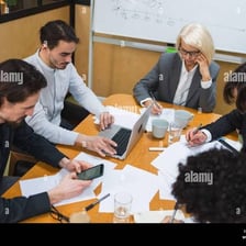 Colleagues seated together and discussing a project.