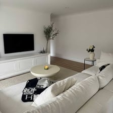 A comfortable couch in a living room facing a television.