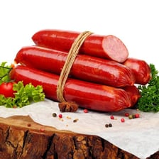 Sliced saveloy sausages arranged on a deli plate.