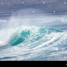Breaking ocean waves with bright white foamy crests.