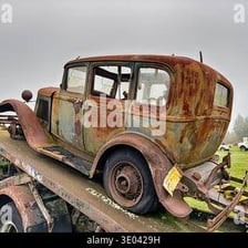 Several old, weathered cars with rusty bodywork.