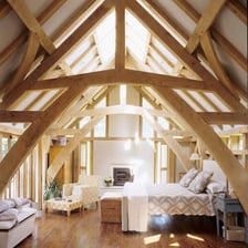 A finished attic room with a sloping ceiling beneath the roof.